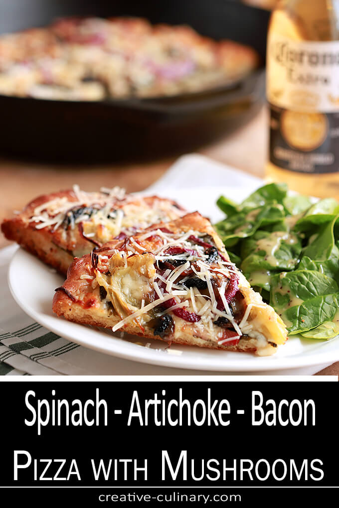 Spinach, Artichoke, Bacon and Mushroom Pizza Served on a White Plate with a Beer