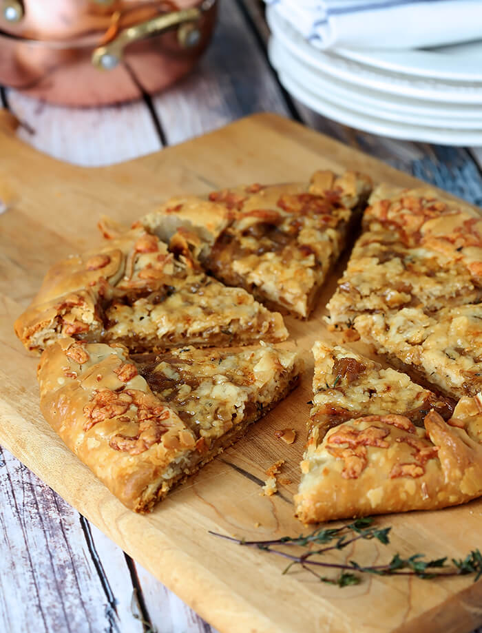 French Onion Galette Sliced on a Cutting Board