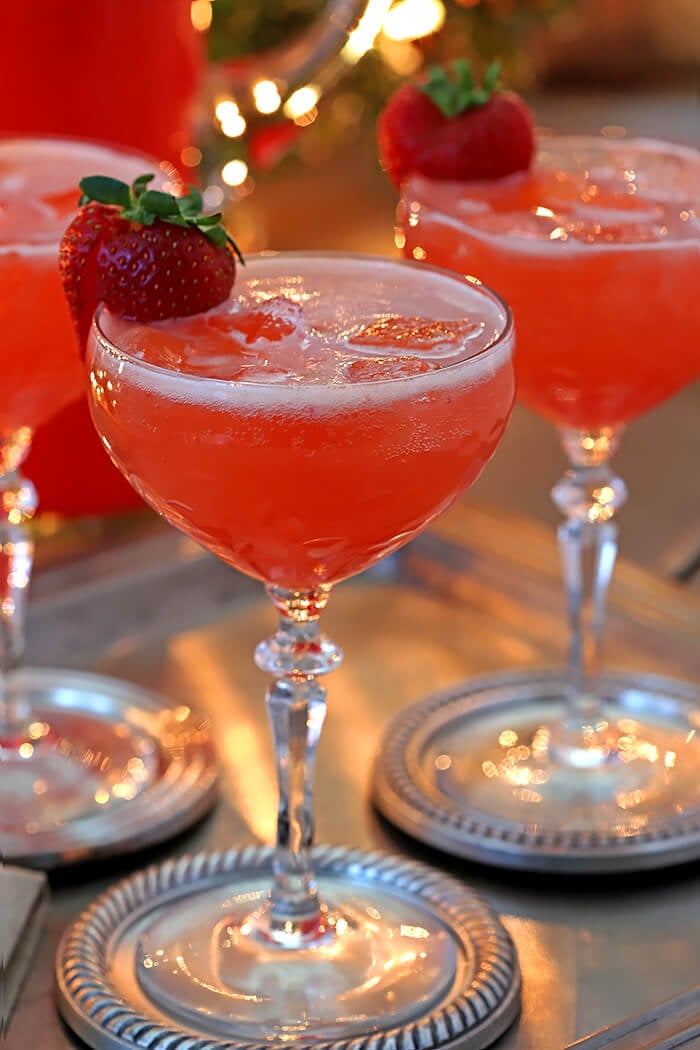 Sparkling Fruit Punch Champagne Cocktail Garnished with Fresh Strawberry