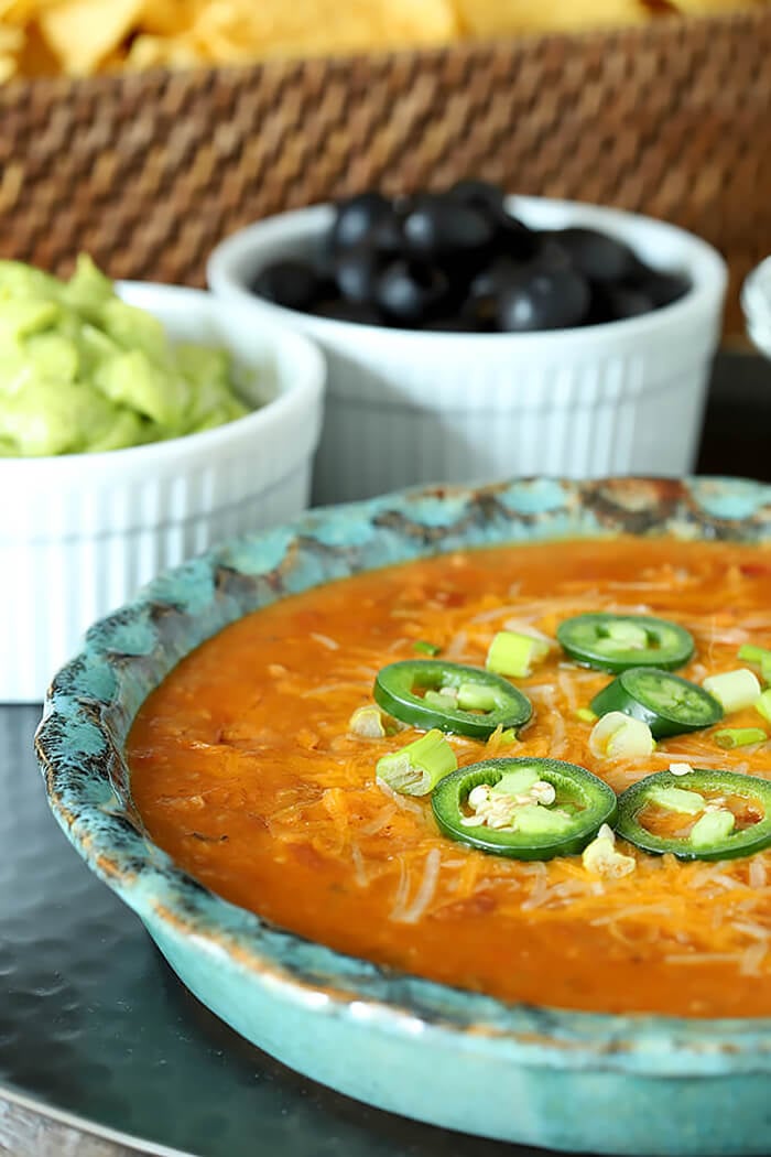 Nacho Mommas Beef, Bean, and Cheese Tortilla Dip Garnished with Jalapeno Slices