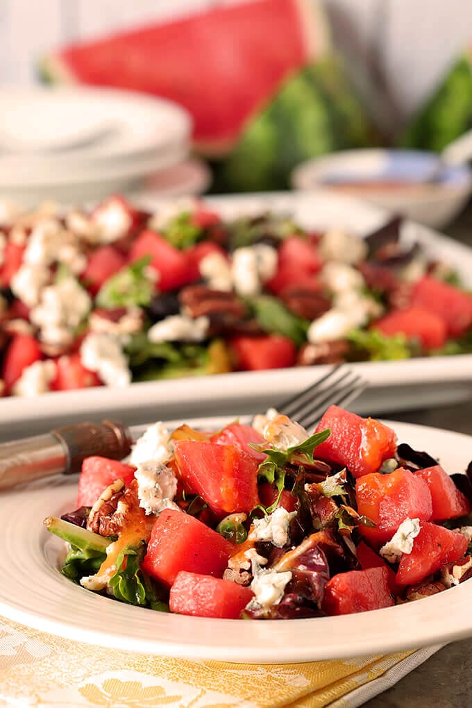 Watermelon Pecan Salad with Gorgonzola Cheese Served on a Round White Plate