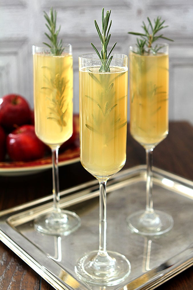 Apple Cider Bellini Cocktail with Rosemary Apple Cider Bellini Cocktail with Rosemary Cocktail Served on a Silver Tray