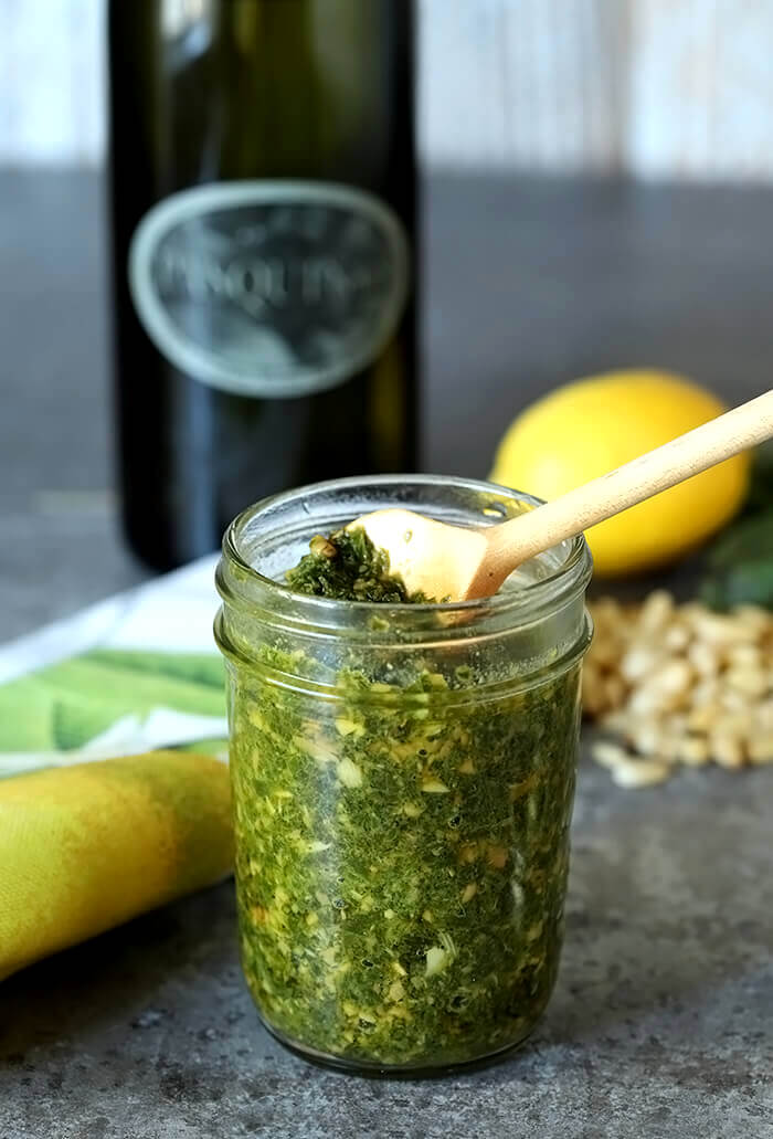 Italian Basil Pesto with Pine Nuts Italian Basil Pesto with Pine Nuts in a Small Jar with a Serving Spoon