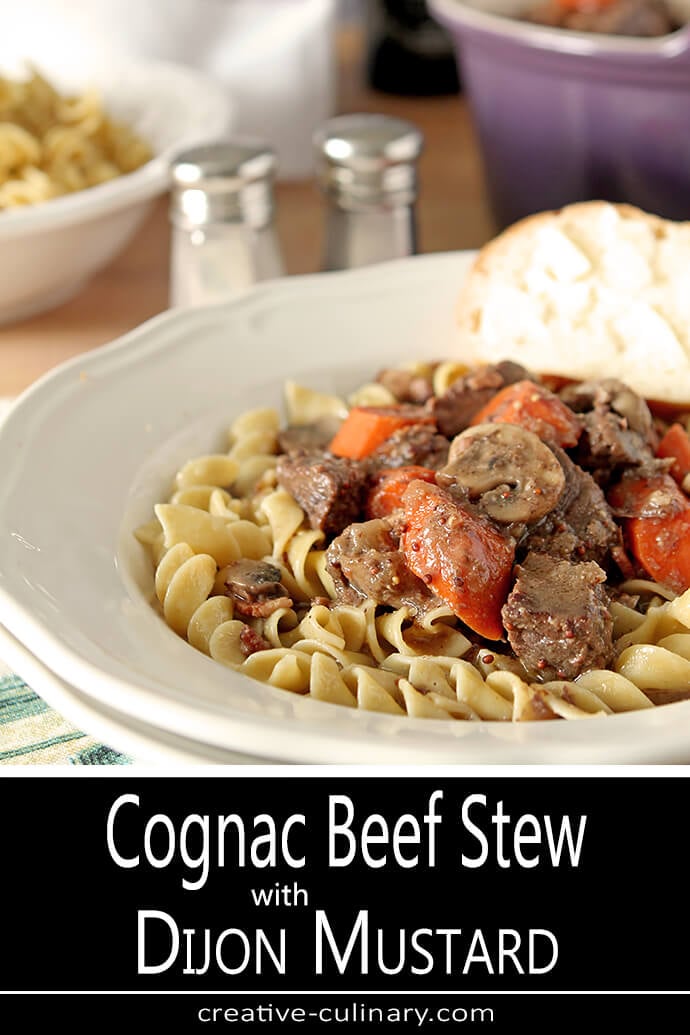 Beef Stew with Dijon Mustard and Cognac over Noodles in a White Bowl