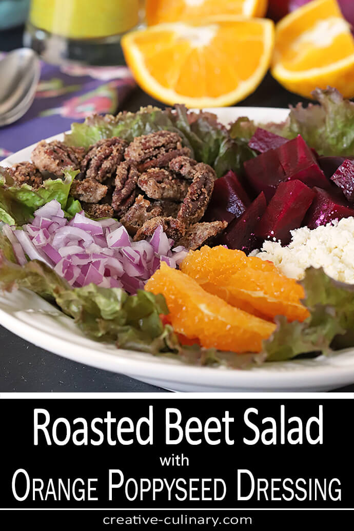 Beet Salad with Oranges, Candied Pecans & Feta Cheese on a Serving Plate with Oranges and Red Onion