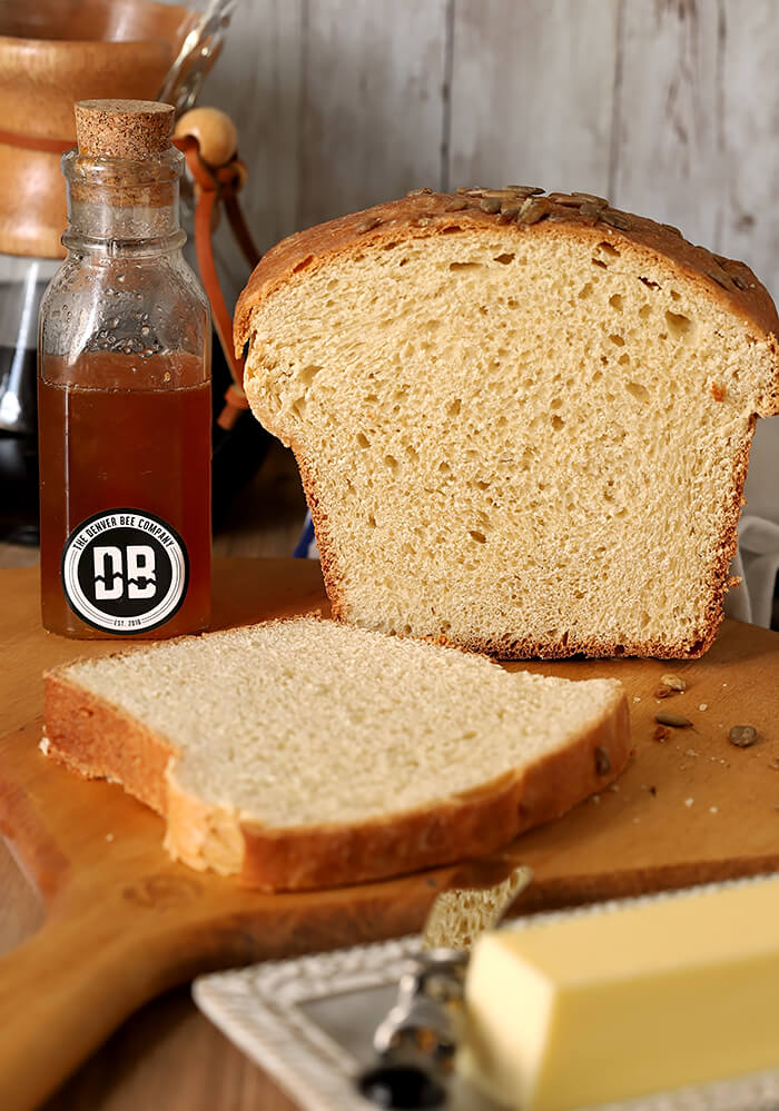 Sliced White Bread with Sunflower Seeds Served with Butter and Honey