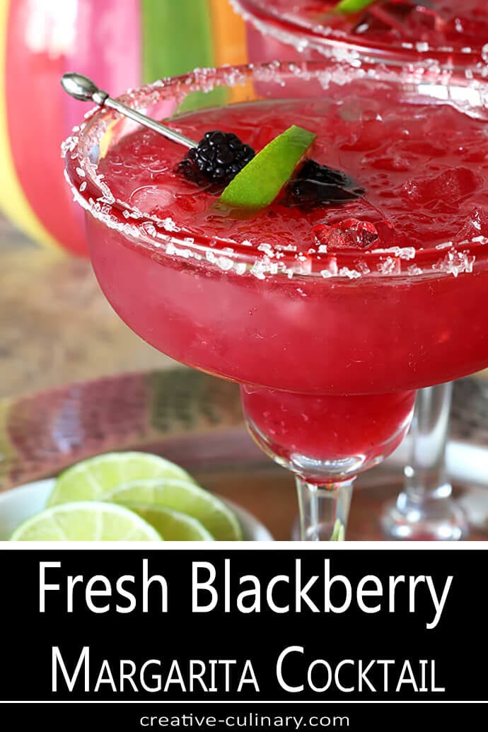 Closeup of Fresh Blackberry Margarita Cocktail Garnished with Sanding Sugar, Blackberries, and Lime Slice