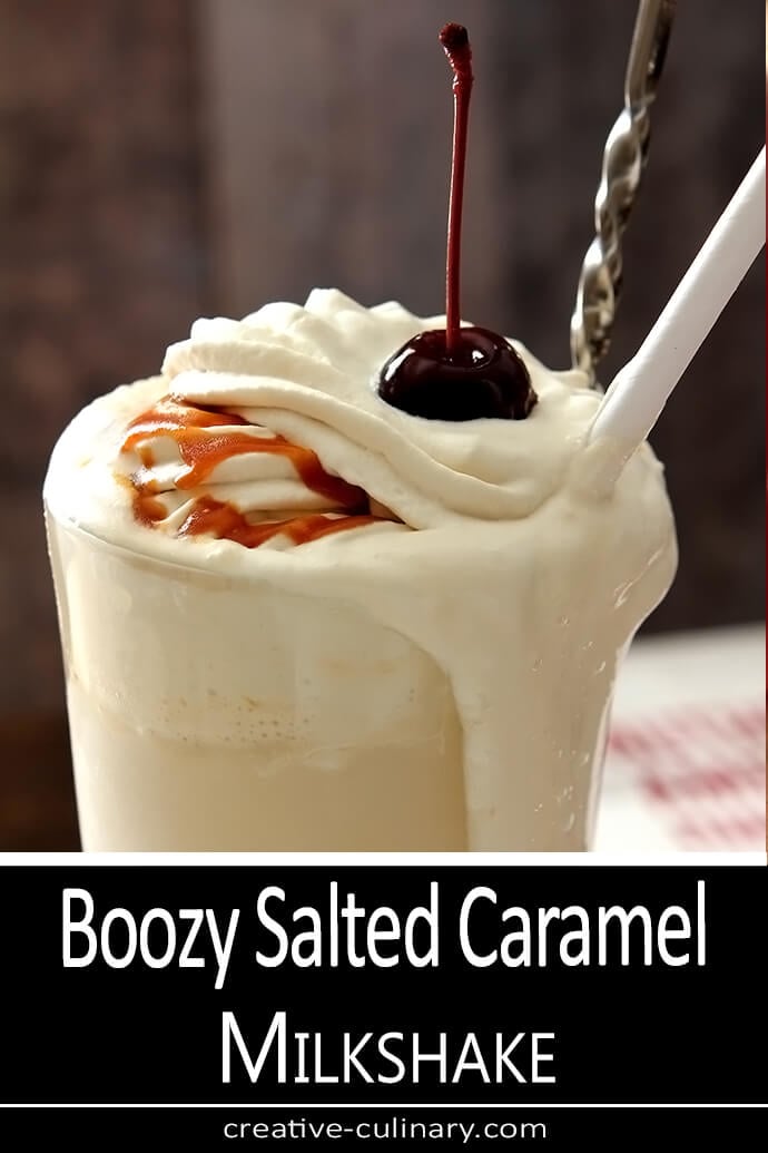 Boozy Salted Caramel Milkshake with Bourbon in an Old Fashioned Sundae Glass with a Cherry on Top