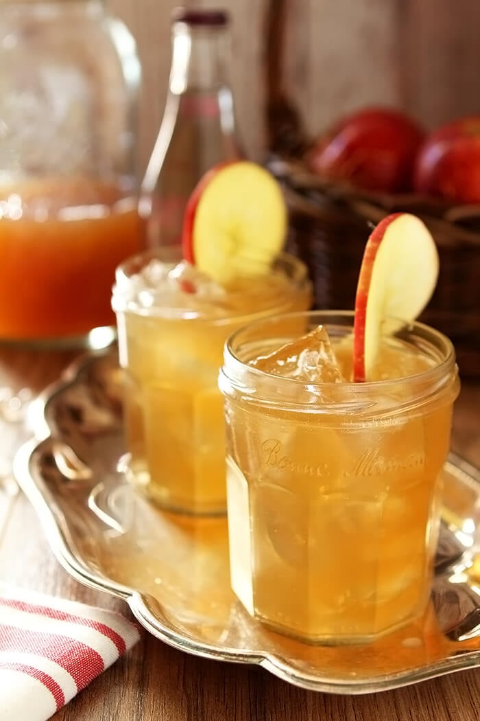 Two Glasses of Bourbon and Apple Cider Cocktail with Ginger Beer Garnished with an Apple Slice