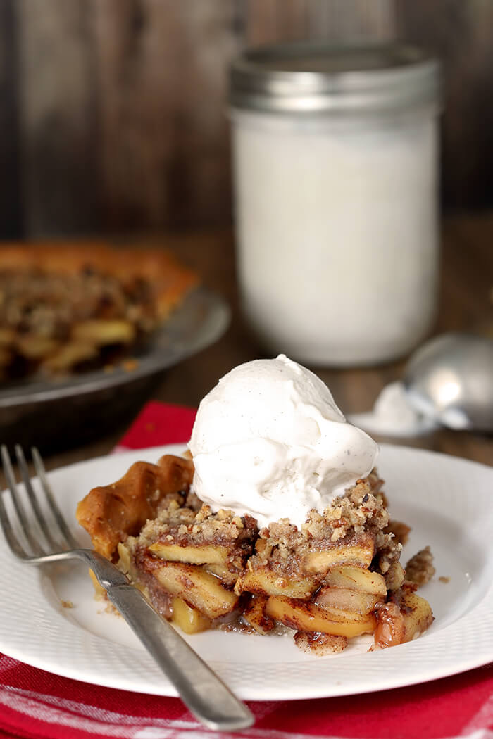 Slice of Bourbon Caramel Apple Pie with Pecan Crumble with Vanilla Bean Ice Cream