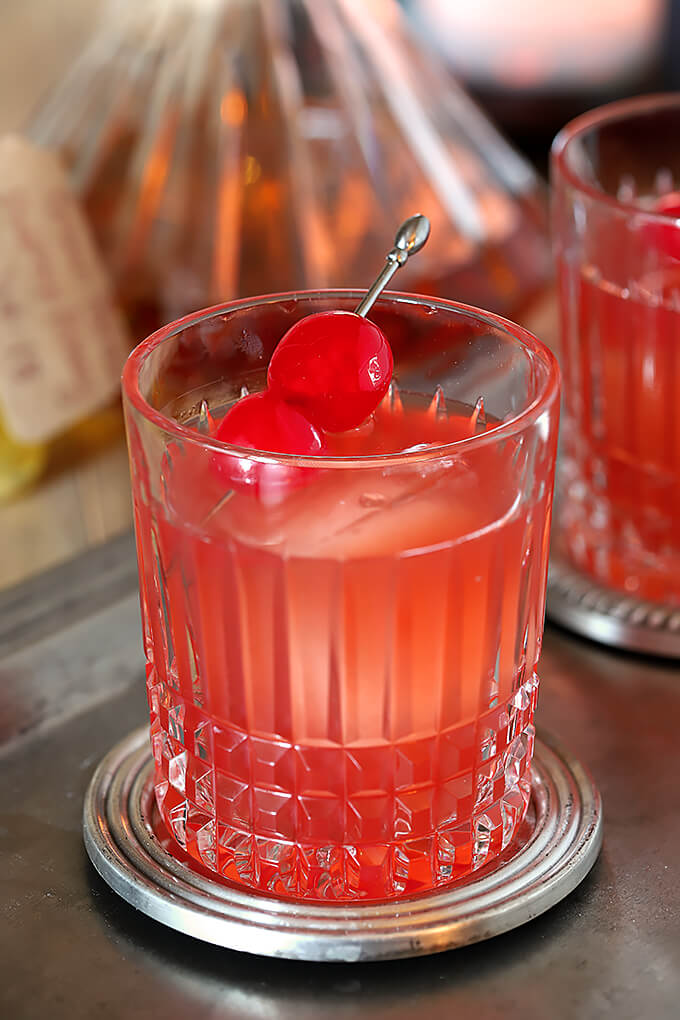 Bourbon and Cherry Old Fashioned Cocktail Closeup with Maraschino Cherry Garnish