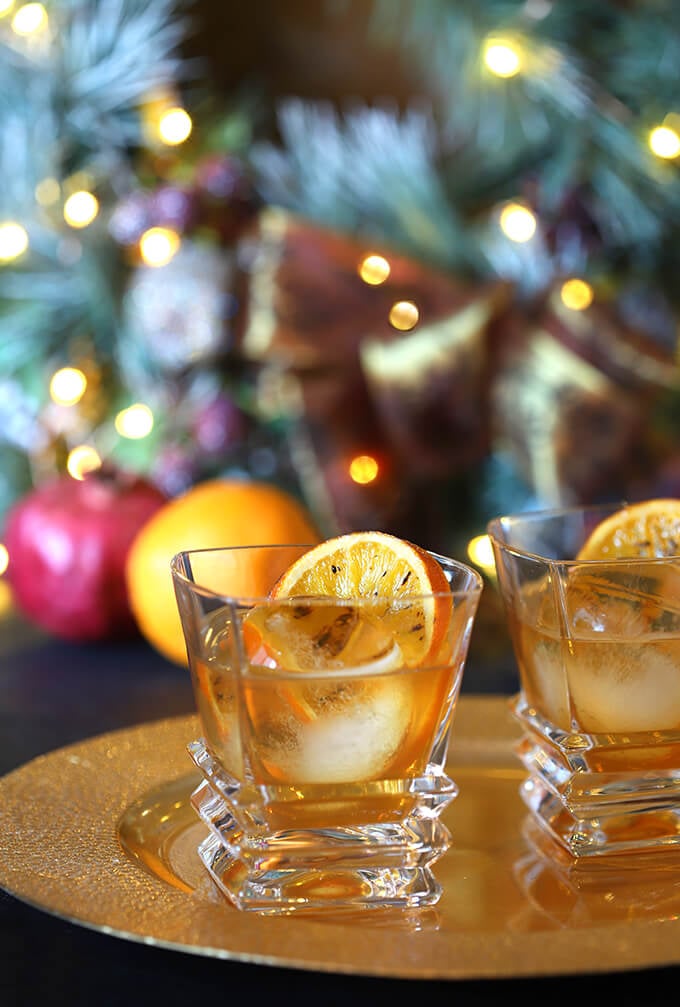 Bourbon and Orange Brulee Cocktails by a Christmas Tree