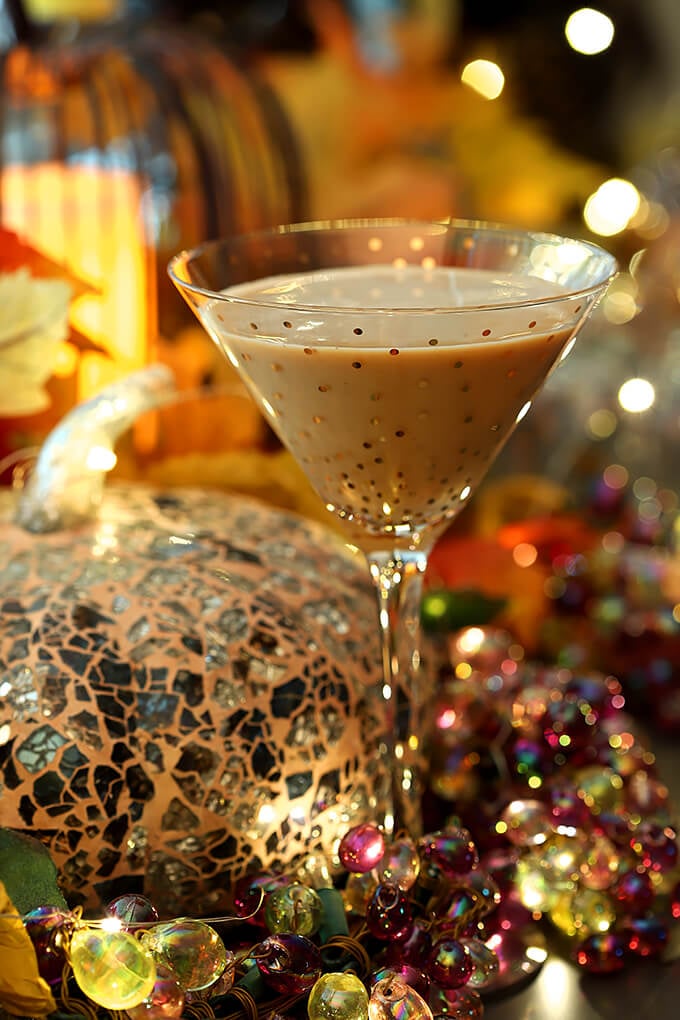 Best Halloween Cocktail Recipes - Bourbon Pumpkin Cocktail with Chocolate Liqueur Served in a Martini Glass with Gold Polk-a-dots