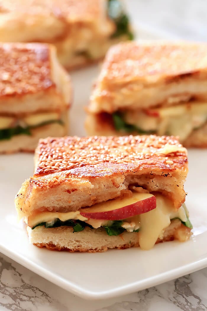 Brie, Apple, and Fig Grilled Cheese Sandwich Brie, Apple, and Fig Grilled Cheese Sandwich served with Potato Chips on a White Plate