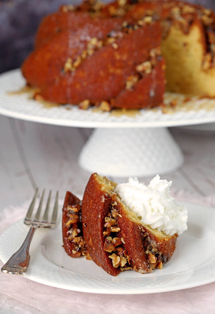 Slice of Easy Rum Cake with Butter Rum Glaze and Whipped Cream