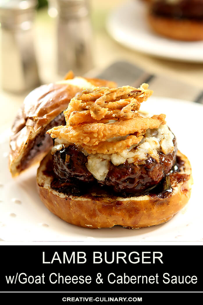 Lamb Burger with Goat Cheese and Cabernet Wine Sauce Topped with Fried Onion Rings and Served on a Bun