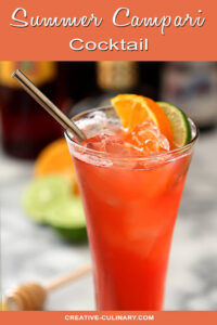 Summer Campari Cocktail in a Tall Glass Garnished with Orange and Lime
