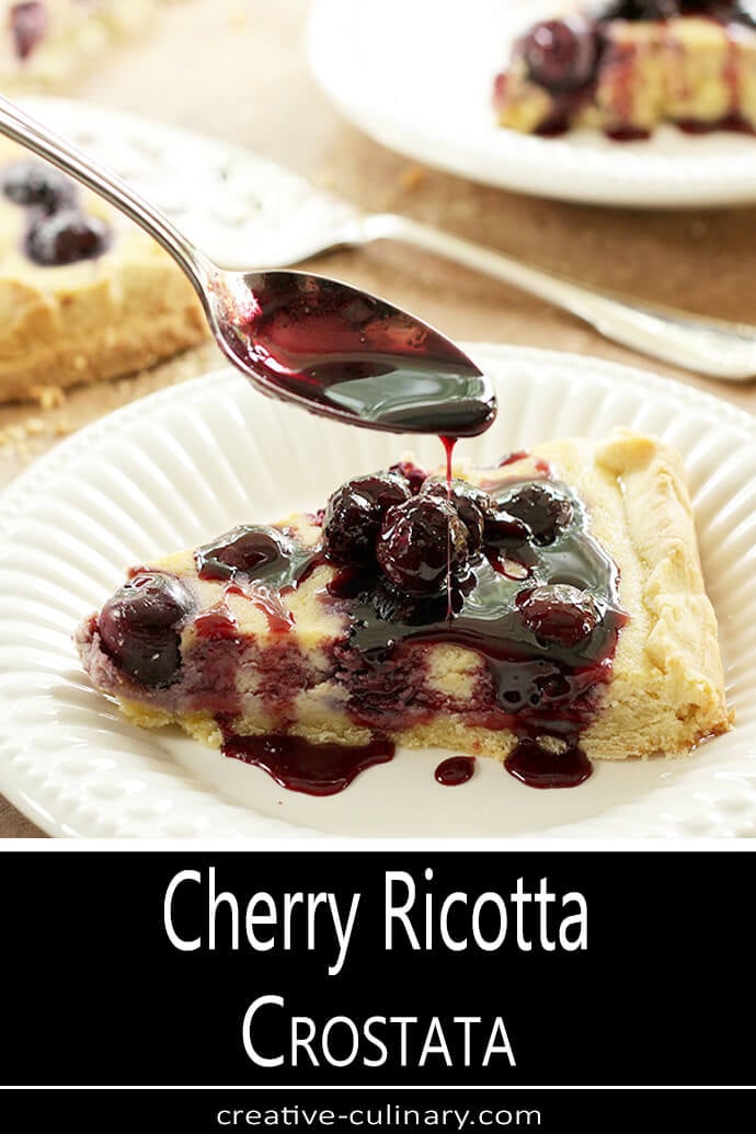 Cherry Ricotta Crostata Served on a White Plate with Cherry Port Sauce Drizzled on Top