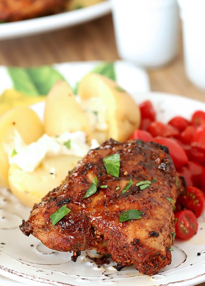 Spanish Tapas Chicken Thighs Garnished with Parsley and Served with Potatoes and Garlic Aioli with Cherry Tomatoes