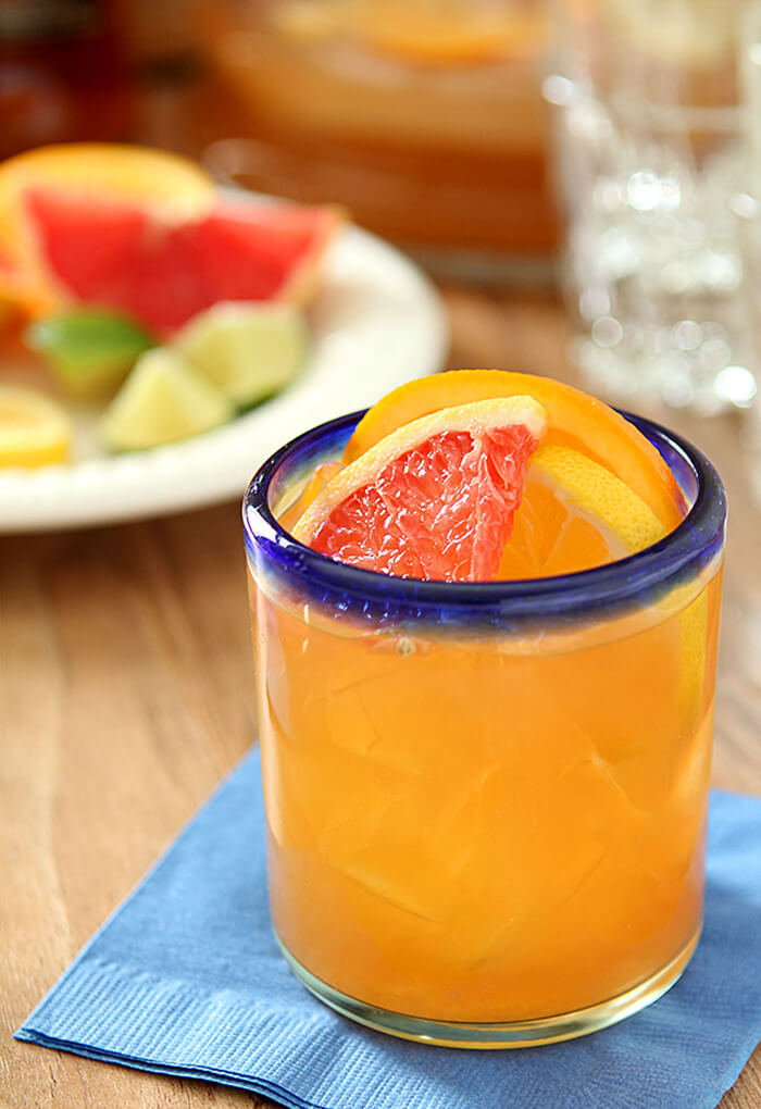 Glass of Citrus Rum Punch Garnished with Grapefruit and Orange Slices