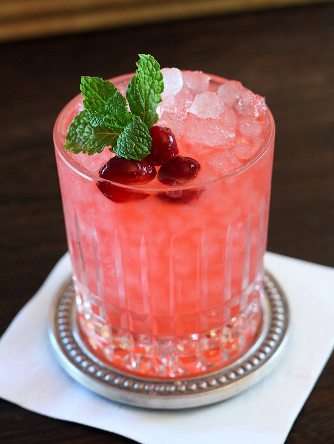 Cranberry Gin Fizz Cocktail Cranberry Gin Fizz Cocktail in a cut crystal glass garnished with Cranberries and Mint.