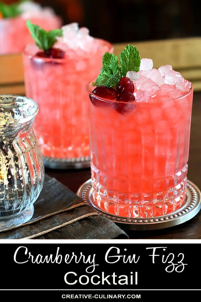 Cranberry Gin Fizz Cocktail in Lowball Glass Garnished with Cranberries and Mint