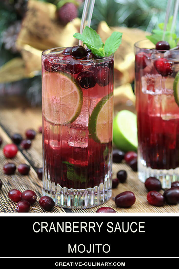 Cranberry Sauce Mojito Cocktails in a Tall Glass Garnished with Cranberries and Mint