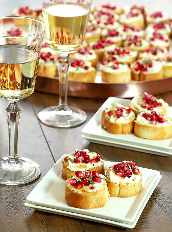 Crostini with Goat Cheese and Pomegranate Arils on Serving Plates