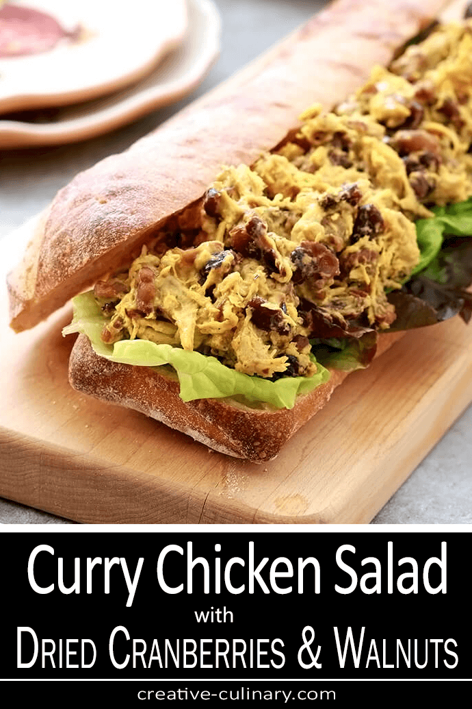 Curry Chicken Salad with Dried Cranberries and Walnuts Served on a Salad Plate with a Pink Napkin
