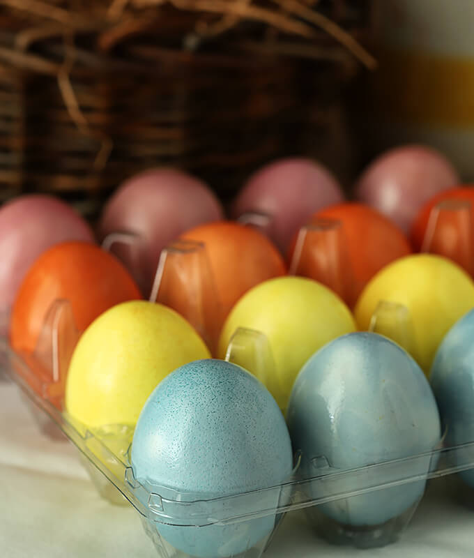 Decorated Easter Eggs with Organic Vegetables and Spices Stacked in an Egg Carton
