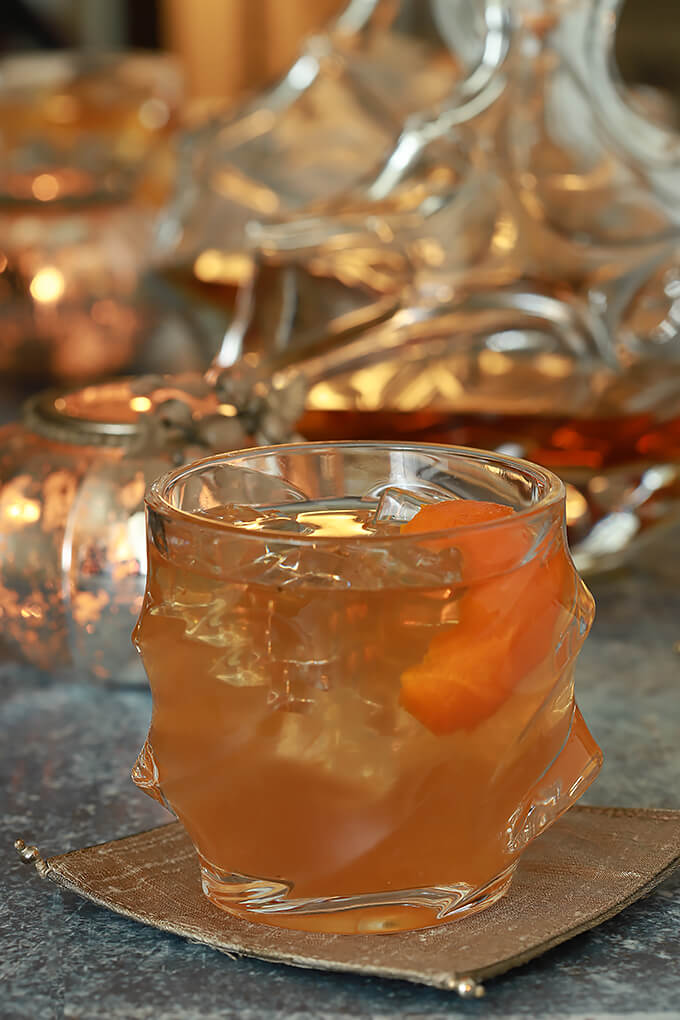 Bourbon and Fig Jam Cocktail Bourbon and Fig Cocktail with Orange Liqueur Served in a Glass with an Orange Twist