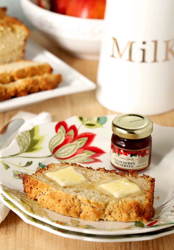 Slice of Honey Butter Beer Bread with a Jar of Strawberry Jam