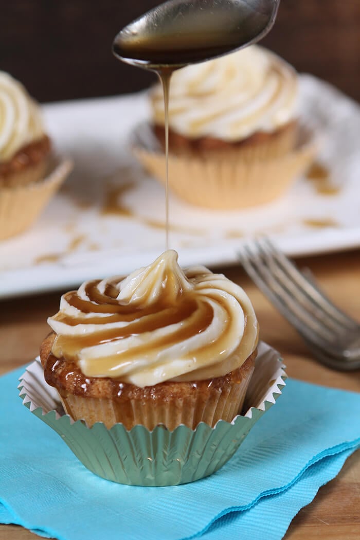 Closeup of Jack Daniels Honey Whiskey Cupcakes with a Boozy Drizzle from a Spoon