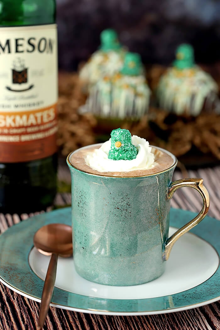 Prepared Hot Chocolate Bomb in Green Cup with Whipped Cream and Green Marshmallow Hat for Garnish