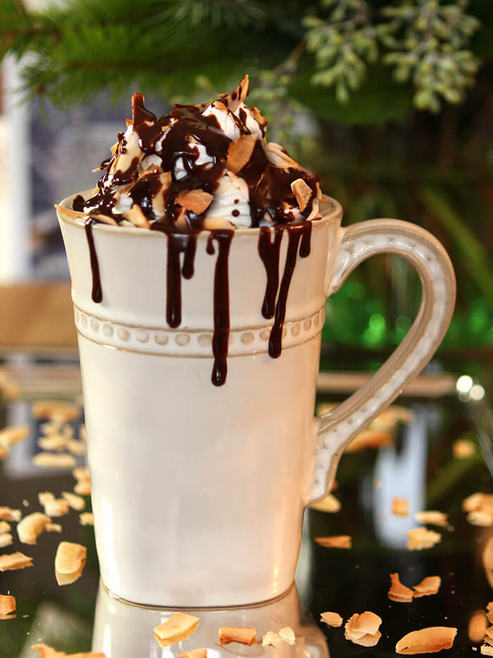 Closeup of Hot Chocoate with Rum, Coconut, and Chocolate Sauce in a Cream Color Mug