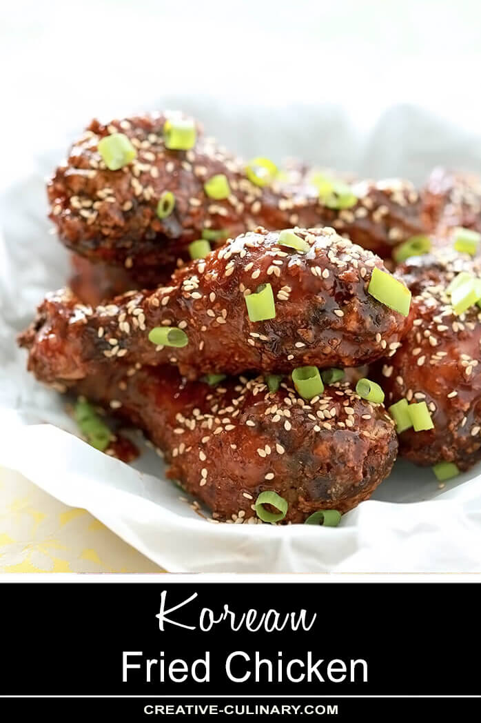 Korean Fried Chicken with Gochujang Sauce and Garnished with Sesame Seeds and Green Onion