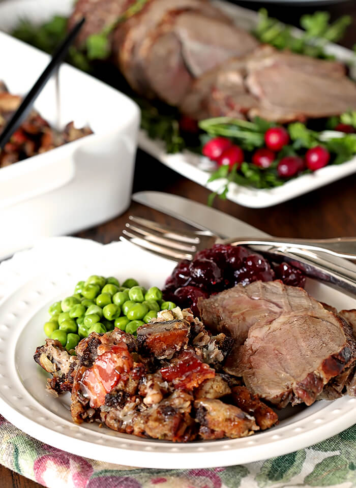 Roasted Lamb with Honey and Thyme and Rye/Pumpernickel Dressing on White Plate