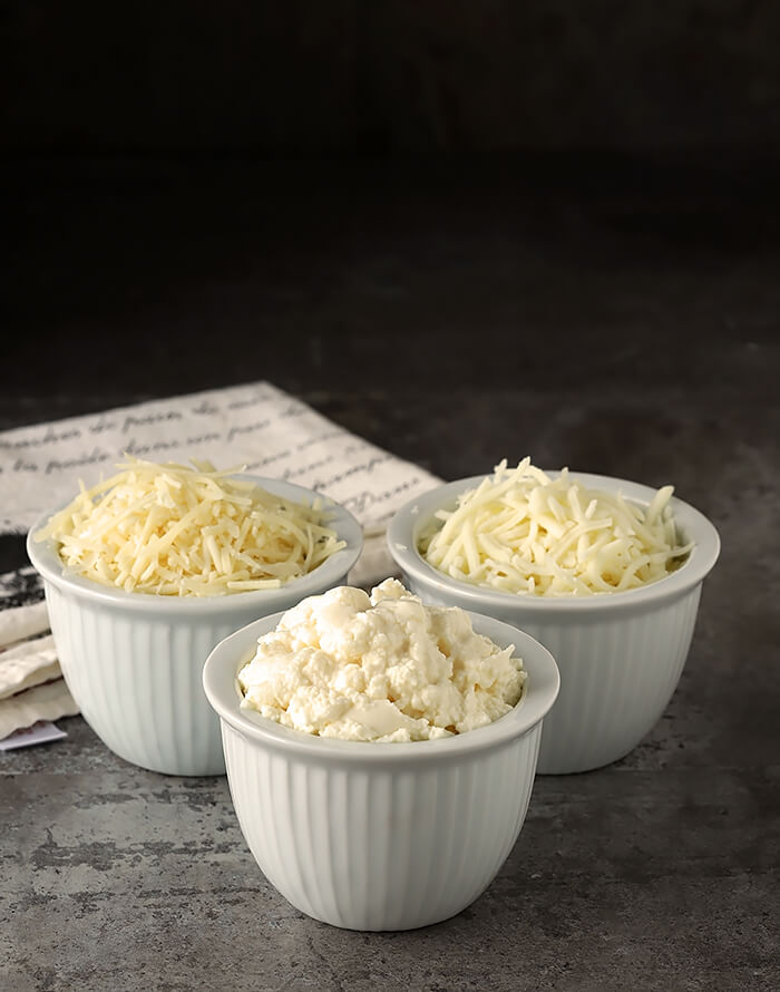 Three Cheeses, Parmesan, Ricotta, and Mozzarella in Small White Serving Cups