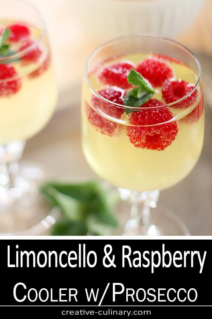 Raspberry, Limoncello and Prosecco Cooler Cocktail Served in a Wine Glass and Garnished with Raspberries and Mint