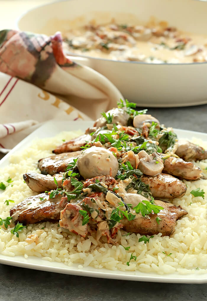 Creamy Mushroom Sauce with Sun-Dried Tomatoes and Spinach Plated on White Serving Plate