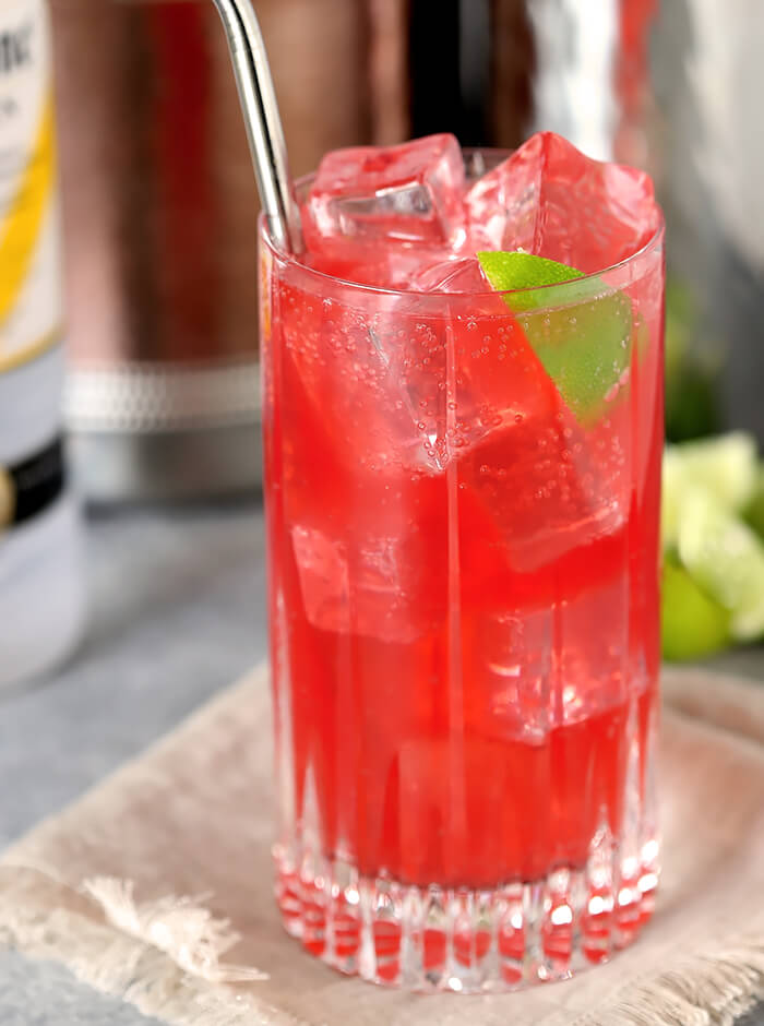 Raspberry Lime Vodka in Tall Glass with Lime Wedge