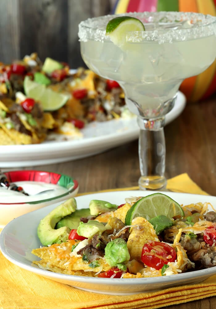 Serving Size Plate of Refried Bean and Beef Nachos With a Margarita