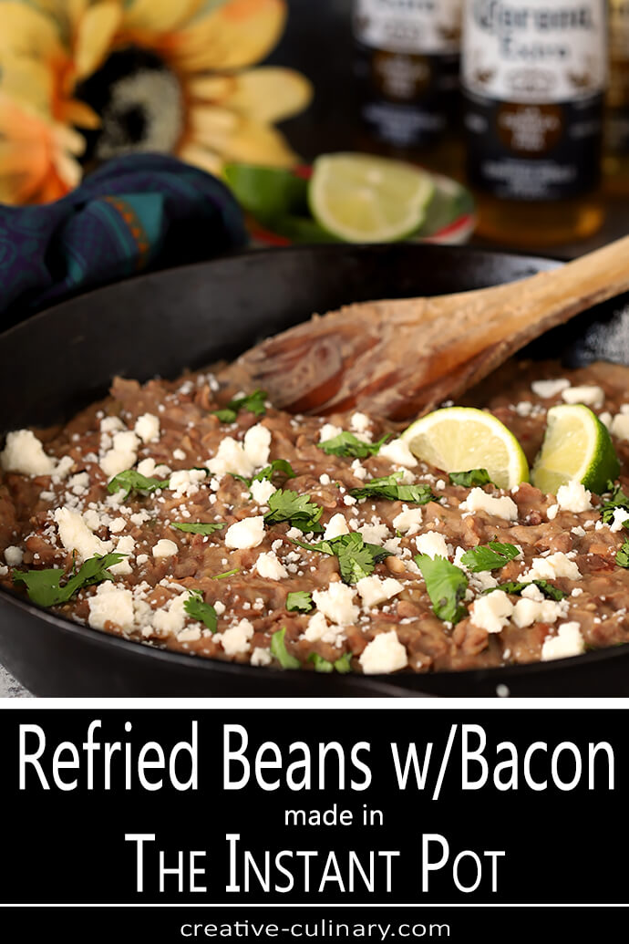 Queso Fresco Cheese and Cilantro Garnish a Cast Iron Skillet Filled with the Best Homemade Refried Beans with Bacon