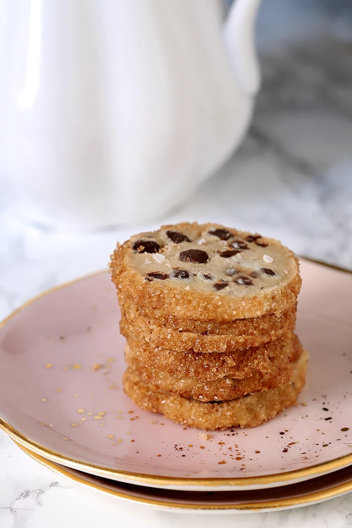 Salted Chocolate Chip Shortbread Cookies Stacked on a Pink Plate on a Marble Surface
