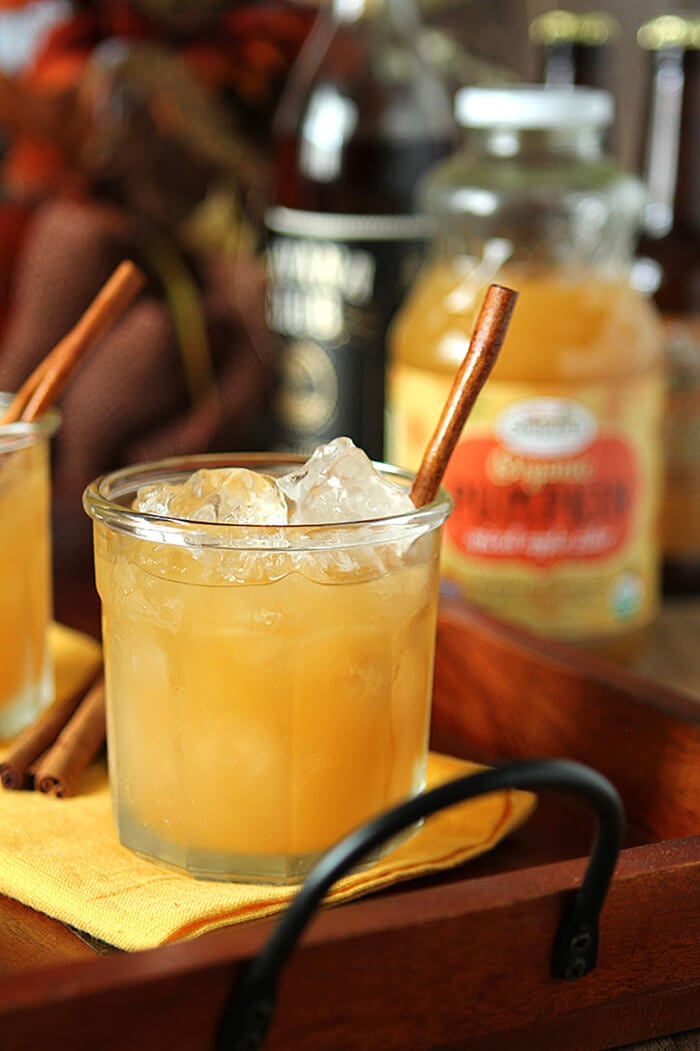 Pumpkin Spiced Apple Cider Cocktail in a Lowball Glass on a Wood and Wrought Iron Tray