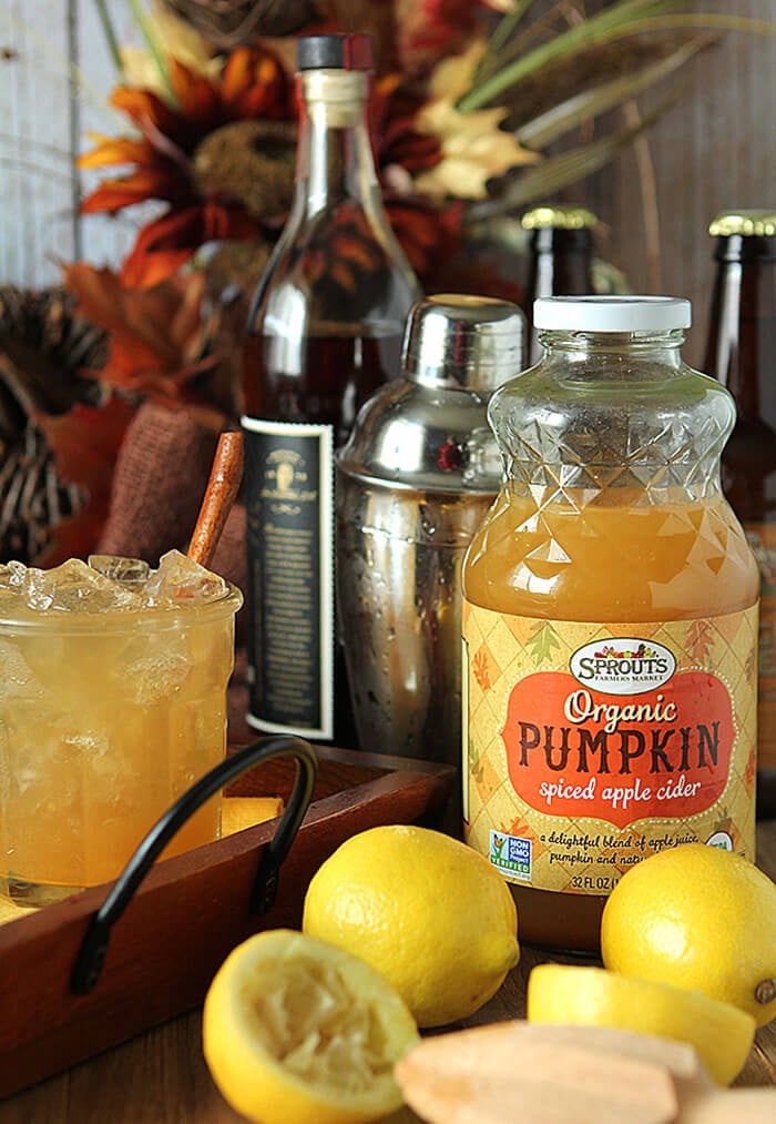 Pumpkin Spiced Apple Cider Cocktail in a Lowball Glass with a Bottle of Havana Club Rum in the Background