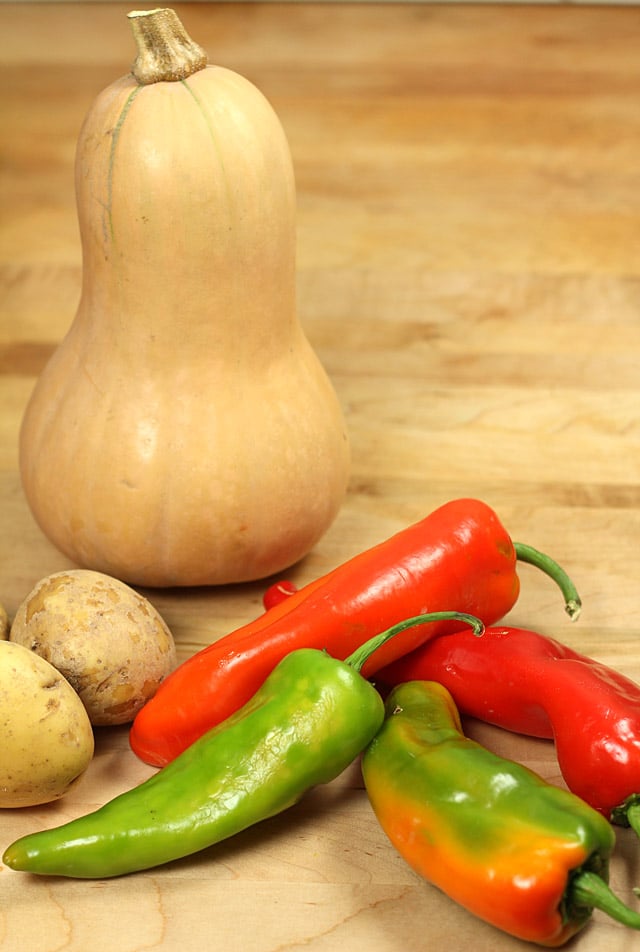 Butternut squash, potatoes, and peppers Butternut squash, potatoes, and peppers on a cutting board