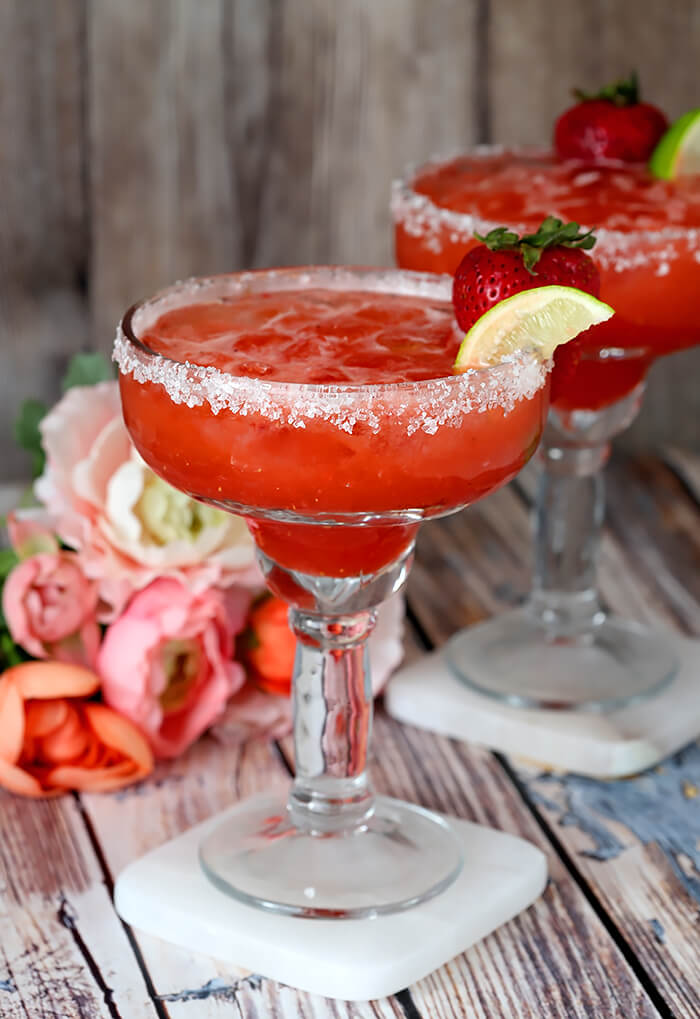 Strawberry Lemonade Margaritas Garnished with a Strawberry and Lime Wedge