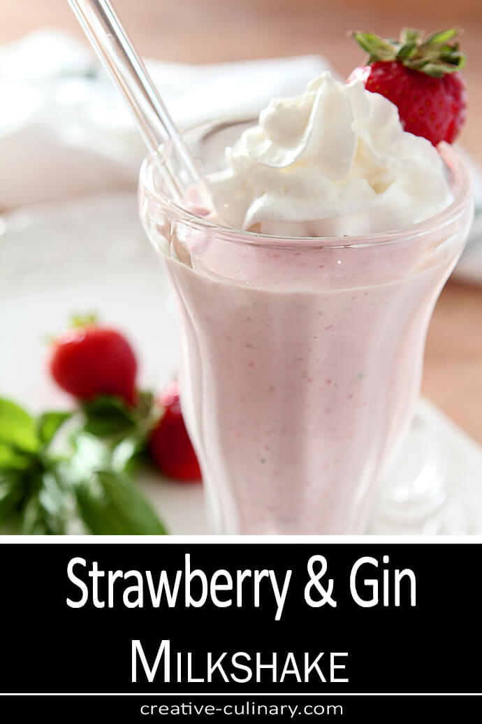 Strawberry and Gin Milkshake served in an old fashioned sundae glass; garnished with a strawberry.