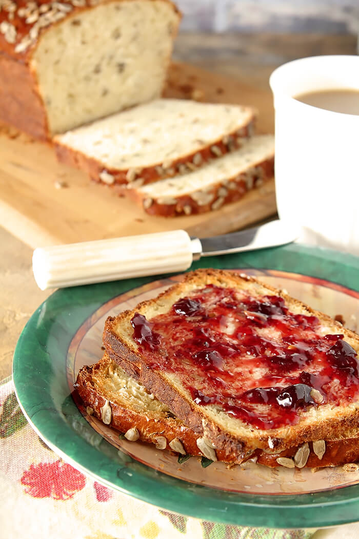 Buttered Slices of Sunflower Seed Bread with Cherry Jam